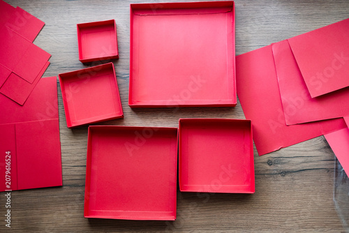 Tableau sur toile Lids from a red collapsible gift box gathered on a wooden table