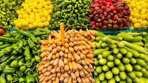 Tableau sur toile Fresh fruits and vegetables arranged in crates in the fruit and vegetable section