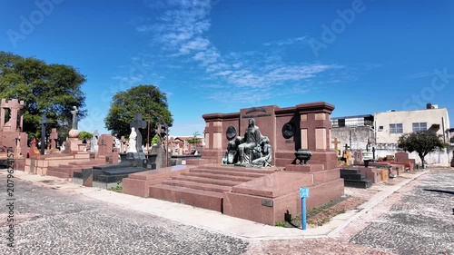 Traditional Cemetery Graves with Large Stone Cross and Statues