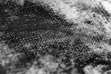 Monochrome macro shot of an inkjet print on a white piece of paper, with interesting patterns and digital textures