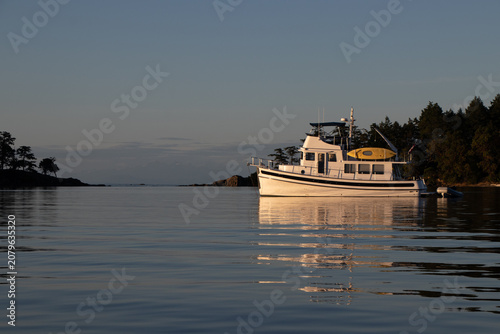 Trawler moored in a tranquil bay at sunset