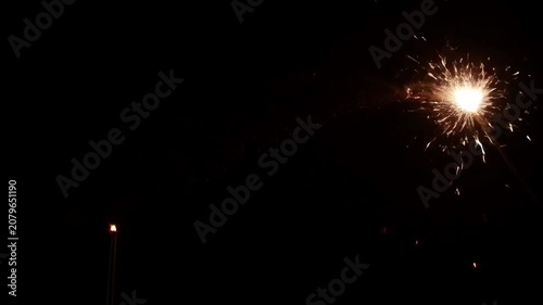 Sparkler ignites the night sky with bright, festive glow.