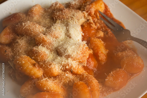 Tableau sur toile Hot steaming gnocchi pasta with marinara sauce and grated cheese close up