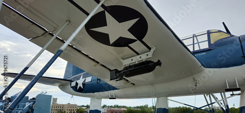 Wilmington, North Carolina, United States - 24 August 2025: View of the vintage military aircraft wing with US military insignia mounted on the deck of the Battleship North Carolina.