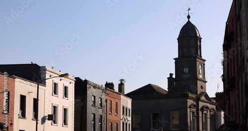 Late afternoon sun illuminates a historic street in the city centre of Drogheda, County Louth, Ireland.
