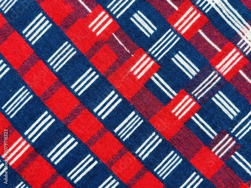 Traditional african kente cloth pattern with red and blue checkered fabric texture and white woven stripes