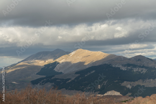 High angle view of a wide mountain valley under cloudy sky in Abruzzo region