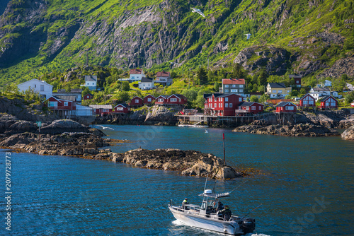 Obraz na plátně Fishing Boat in Lofoten Islands Norway with Red Rorbuer Houses