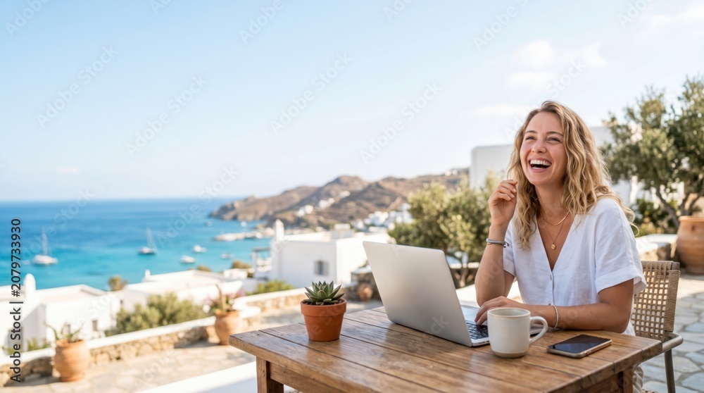 Fototapeta premium Happy young woman working remotely on laptop at outdoor terrace with sea view, digital nomad lifestyle concept, freelance professional enjoying summer vacation