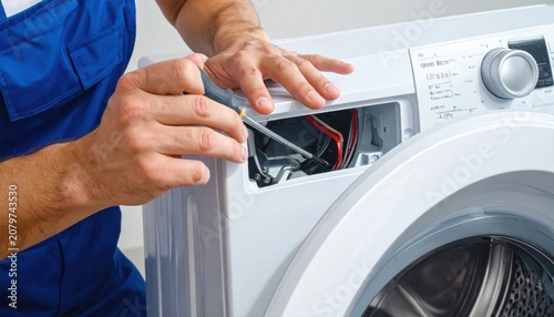 Professional technician repairing washing machine with screwdriver, appliance maintenance and home appliance troubleshooting service