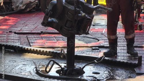 Drilling rig activity - Pull of of hole drill string with oil based mud on the rig floor. Trip out of hole.