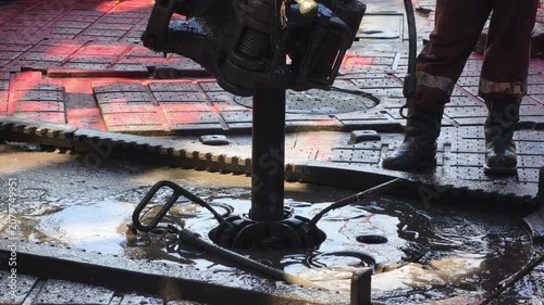Drilling rig activity - Pull of of hole drill string with oil based mud on the rig floor. Trip out of hole.