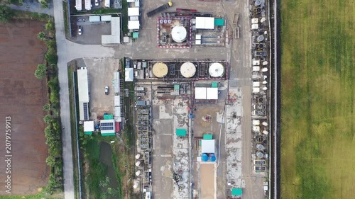 Oil and gas a land rig, onshore drilling rig, in the middle of a rice field aerial view from a drone