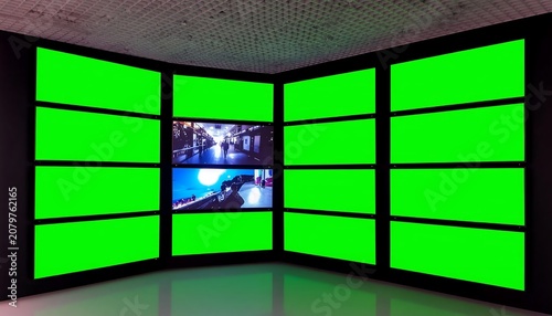 Modern corner display with vibrant green screens.