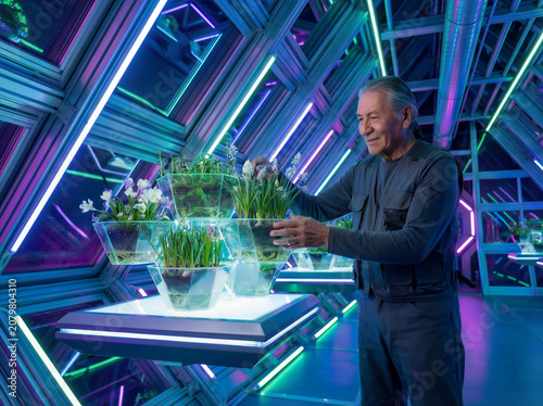 Man tending plants in futuristic indoor garden