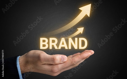Brand Growth and Brand Development Concept with Upward Arrows and Human Hand