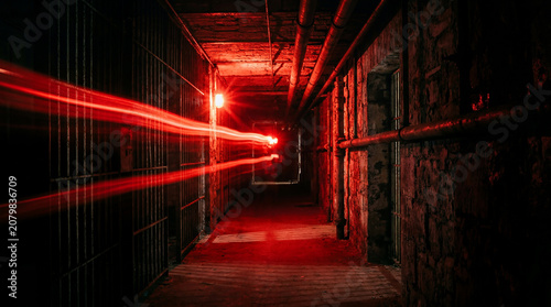 Bright Emergency Red Flashing Light Illuminating A Pitch Dark Penitentiary Facility Corridor Without Anybody Present