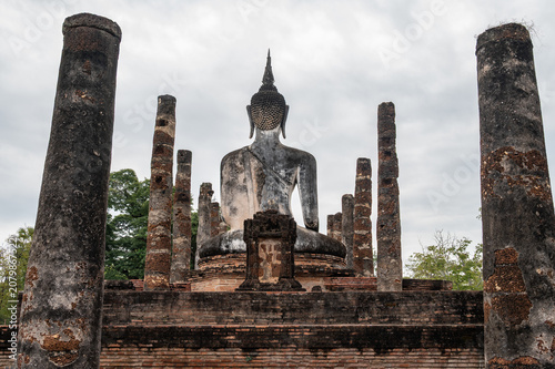 Konstfotografi Rear view of old Buddha statue seated in Wat Mahathat temple the most important and impressive temple compound in Sukhothai Historical Park