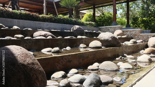 Canvastavla open garden design behind the house using real river stones and a gurgling water