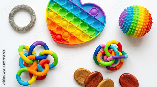 Colorful fidget tools arranged in flat lay, showcasing various textures and shapes