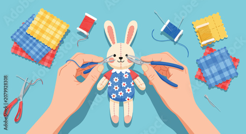 Craftsman hands use pliers and needles to assemble a cute handmade plush bunny toy surrounded by fabrics and sewing tools.
