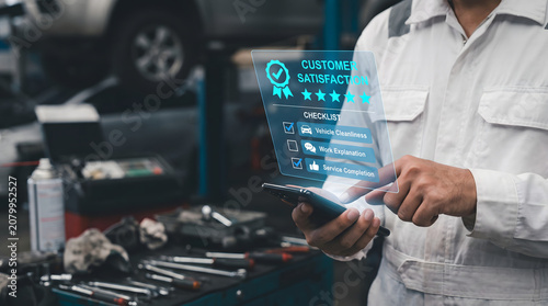 Man in white uniform holding tablet with customer satisfaction review in garage workshop with tools