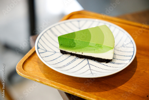 Green tea cake pie with gradient layered in cafe.