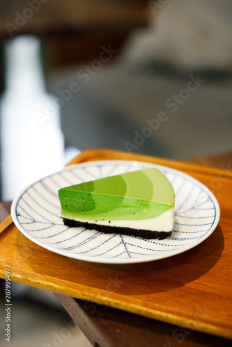 Green tea cake pie with gradient layered in cafe.