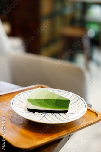 Green tea cake pie with gradient layered in cafe.