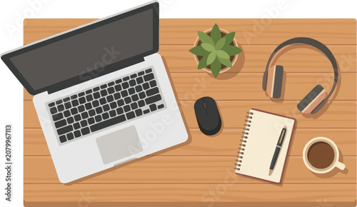 Notebook rests on a wooden desk next to a laptop and headphones for a productive work flow.