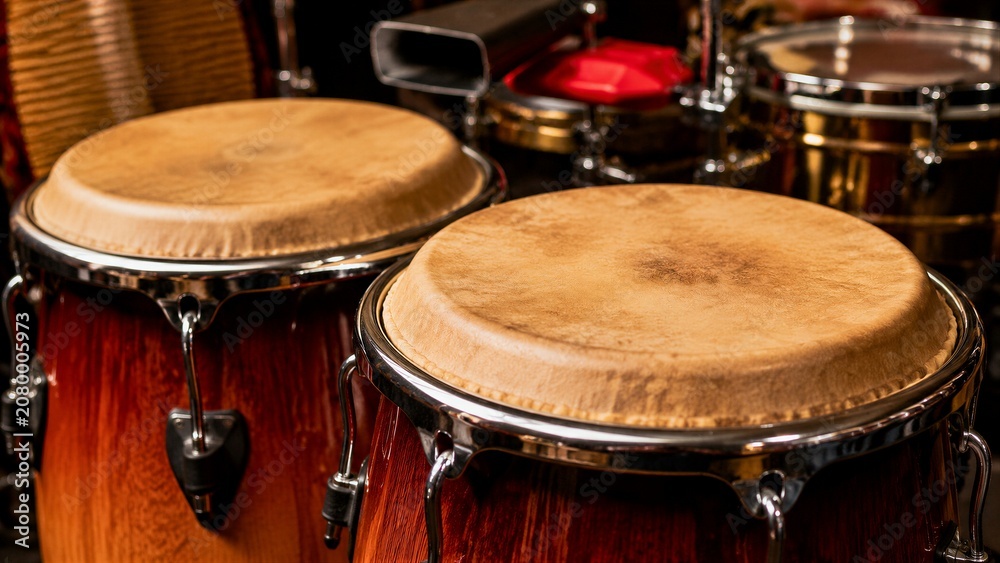 Obraz premium Wooden conga drums resting on percussion setup inside music studio