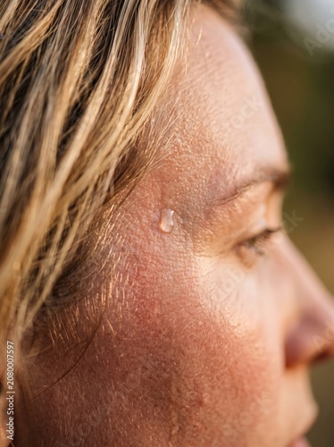 Sweat droplets on face of woman close up