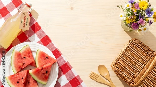 Fresh sliced watermelon on checkered picnic blanket with wooden cutlery