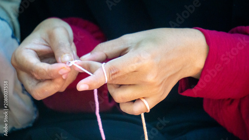 Creating items (lipstick holder) using the craft of knitting. An activity in leisure time.