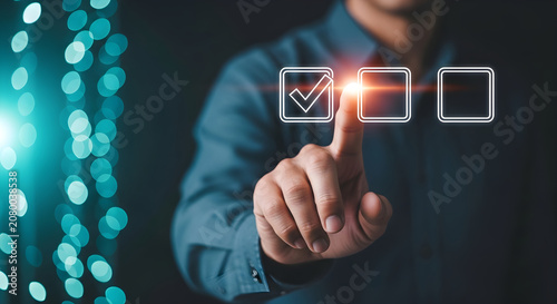 A person interacts with glowing interface elements in a dark room