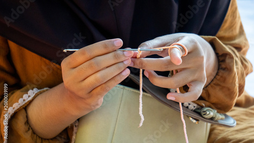 Creating items (lipstick holder) using the craft of knitting. An activity in leisure time.
