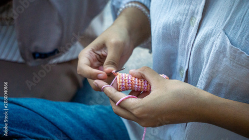 Creating items (lipstick holder) using the craft of knitting. An activity in leisure time.