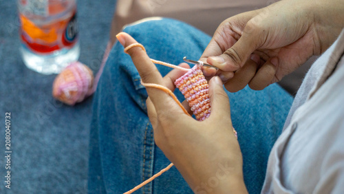 Creating items (lipstick holder) using the craft of knitting. An activity in leisure time.