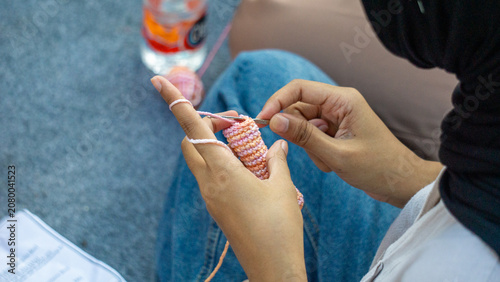 Creating items (lipstick holder) using the craft of knitting. An activity in leisure time.