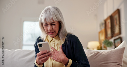 Bild auf Leinwand Stress, old woman and chest pain at house with phone, research and symptoms for heart attack