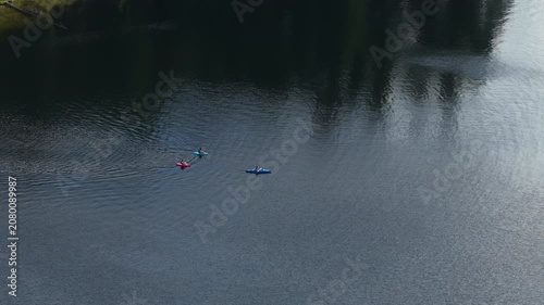 Aerial of recreational kayaks paddling on calm lake in Stevens County in northern Washington in summer