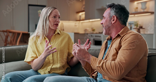 Konstfotografi Argument, dispute and couple on sofa in home with conflict, disagreement or communication in marriage