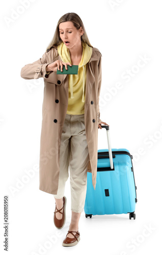 фотографія Woman surprised looking at passport while traveling with suitcase