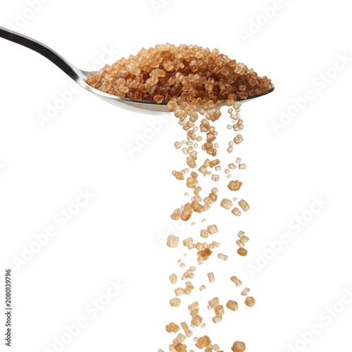 Brown sugar crystals cascading from a polished metal spoon against a transparent background, individual grains frozen in mid-air, culinary ingredient atmosphere