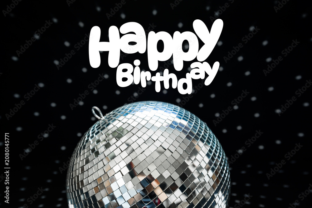 Fototapeta premium Happy birthday celebration with a disco ball and festive decorations in a dark setting