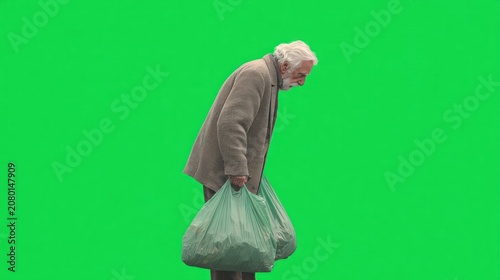 Elderly man, bent over, carrying bags