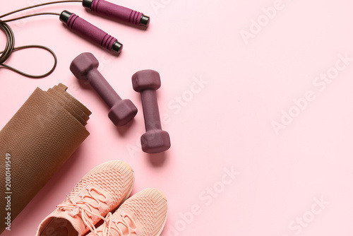 Yoga mat with brown dumbbel...