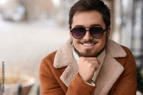 Stylish young man with sung...