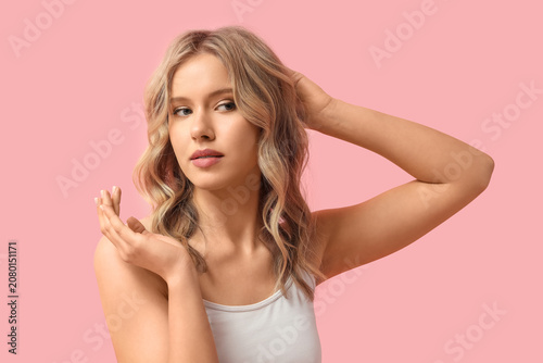 Blonde young woman with cur...