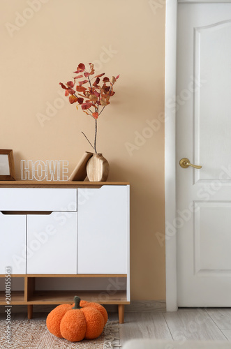 Vase with autumn leaves on ...
